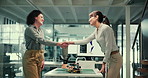 Women, scientist and together for handshake, deal and happy for agreement for patent of prosthetic design. People, bionic engineer and shaking hands for partnership, success or manufacturing contract
