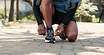 Shoes, man and hands tying lace for fitness, safety and ready for run on nature path. Runner, feet and secure sneakers in park for training, wellness and sports preparation with care for wellbeing