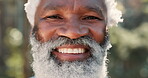 Face, senior and smile of black man outdoor in nature for adventure, exercise or hiking closeup. Fitness, portrait and retirement with happy old person in forest or park to explore Kenya wilderness