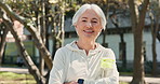 Face, fitness and senior woman outdoor with water for exercise, health or wellness. Portrait, smile and confident person with bottle for hydration, training and workout with arms crossed in Ireland
