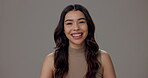 Portrait, laugh and woman with smile, natural makeup and confidence on grey studio background. Face, happy model and satisfaction with cosmetic, salon grooming and facial treatment for beauty glow