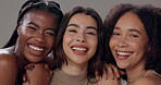 Women, smile and skincare with diversity in studio for dermatology, beauty or solidarity on gray background. Friends, face and laughing with support for self care, cosmetics or facial transformation
