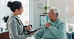 Woman, elderly patient and physiotherapist with tablet for consultation, healthcare or shoulder injury at clinic. Female person, therapist and senior with pain, discomfort or sore muscle for therapy