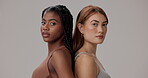 Serious, women and face with skincare in studio for natural beauty, cosmetics and confidence. Unity, support and portrait of people with pride for dermatology, treatment or results on gray background