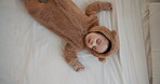 Cute, development and growth with baby sleeping on bed of home in onesie for rest from above. Comfort, dreaming and relax with infant child asleep in bedroom of apartment for peace or quiet 