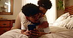 Couple, relax and hugging on bed with phone for social media post, streaming subscription and embrace in home. People, happy and romance with smartphone for online scroll, watching videos and bonding