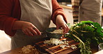 Hands, couple and cooking onions in kitchen with meal prep, healthy dinner and vegetable ingredients. People, food and fresh produce with spinach and vegan recipe for nutrition and wellness in house