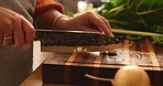 Hands, kitchen and woman chop garlic for cooking healthy dinner, meal or culinary food at home. Knife, ingredients and closeup of female chef cut vegetables for diet, nutrition or wellness supper.