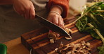 Hands, kitchen and woman chop mushroom for cooking healthy dinner, meal or culinary food at home. Knife, ingredients and closeup of female person cut vegetables for diet, nutrition or wellness supper