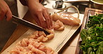 Hands, kitchen and woman cut chicken for cooking healthy dinner, meal or culinary food at home. Knife, ingredients and closeup of female person chop poultry meat for diet, nutrition or protein supper