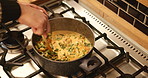 Cooking, food and pot with hands of person in kitchen for health, vegetables and energy. Wellness, nutrition and diet with chef and stir ingredients in home for homemade meal, detox or organic dinner