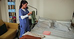 Nurse, woman and home care with folding clothes in retirement for elderly patient as caregiver. Female person, duty and chores in nursing village for senior people in bedroom for support as assistant