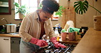 Cleaning, stove and woman with gloves, dirty and soap for prevention of germs, frustrated and routine. Person, disinfection  and fabric for protection, confused and washing for virus and scrub