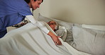 Senior woman, caregiver and blanket in bed for cover, care or support in nursing home. Elderly patient, nurse or duvet in bedroom for warmth, comfort or help in assisted living or trust in retirement