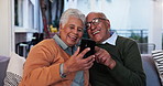 Elderly couple, phone and happy on sofa for video call, communication and networking. Senior people, mobile and smile in home for family contact, social media and bonding and relax in living room