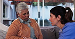 Nurse, listening and empathy with old woman on sofa in living room for Alzheimer, cognitive support and helping others. Healthcare, medical and senior care with people in retirement home for sympathy