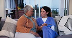 Nurse, compassion and empathy with old woman on sofa in living room for Alzheimer, cognitive support or helping others. Healthcare, medical and senior care with people in retirement home for sympathy