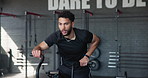 Fitness, tired and exercise bike with man in gym for training, muscle connection and workout. Health, strong and sports athlete with male person and equipment for energy, sweat and strength movement