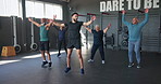 People, fitness and exercise with jumping jacks for workout, wellness and strong muscle in studio, class or gym. Group, trainer and aerobics with warm up, sports and endurance for physical training