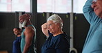 Senior people, stretching and class in gym with exercise for fitness, warm up and healthy body. Serious, group and training with flexibility in preparation for retirement, workout, and wellness