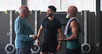 Mature man, personal trainer and friends in gym for exercise, workout or training. Physical therapy, elderly support and help with routine with fitness, discussion and wellness for retirement health