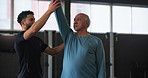 Elderly man, instructor and senior aerobics class with warm up, endurance and physical training. Stretching, fitness and exercise with arm for workout, wellness and muscle in club, studio and gym