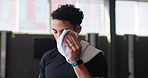 Exercise, sweat and towel with man in gym for intense challenge, performance or workout. Fitness, training and wipe with exhausted or tired athlete person in health club for break, recovery or rest