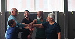 Celebration, huddle and motivation with senior fitness class in gym together for success or support. Exercise, fitness or team building with old people and trainer in health club for training