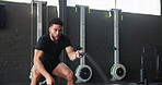 Fitness, cardio and battle rope with man in gym for training, muscle connection and workout. Health, strong and sports athlete with male person and equipment for energy, wellness or strength movement