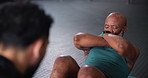 Exercise, trainer and helping mature man with sit ups in gym for retirement wellness, core strength and healthy body. People, instructor and workout support in sports club for performance or counting