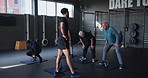 Coach, group and kettlebell in gym for fitness with senior people with muscle development in retirement. Person, elderly men and women with weightlifting for workout, training or exercise in class