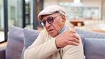 Elderly man, stress or shoulder pain on sofa with stretching, anxiety or massage joint for care. Senior person, injury or muscle ache in home with crisis, physical therapy or arthritis in retirement