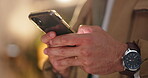 Hands, man and phone in office at night for typing communication, social media and information of business. Male person, mobile and scroll for research, reading email and contact of overtime feedback