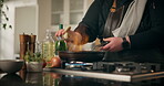Food, fire and frying pan with hands of person in kitchen for cooking, flame and meal prep. Nutrition, cuisine and dinner with chef and flambe at home for wellness, dining and healthy ingredients
