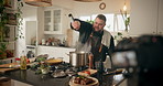 Chef, influencer and man in kitchen for cooking dinner, cuisine and meal preparation in home. Live streaming, content creator and person with food, recipe and culinary tutorial for social media vlog