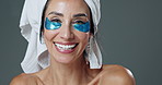 Face, eye patch and woman in studio, smile and application for dark circles, beauty and wellness. Skincare, happy and treatment of dermatology, model and product to reduce inflammation in spa