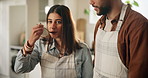 Couple, taste and food with cooking in kitchen for meal prep, nutrition lunch and bonding together of romance. Woman, man and spoon for eating, healthy dinner and recipe helping of date at house 