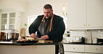 Cutting board, cooking and man in kitchen, vegetables and meal preparing for event, chopping or restaurant. Recipe, chef and person with ingredients for culinary, seasoning or frying of food in hotel