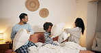 Family, playing and pillow fight in bedroom, energy and child for freedom entertainment in home. Parents, son and relax together for bonding in relationship, happiness and weekend games for love