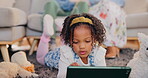 Child, relax and tablet on floor for games, media and streaming cartoon show at home. Young girl, tech and fun in living room with entertainment, virtual pet play and educational app for elearning