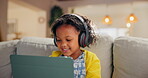 Girl, child and tablet for music in home, online education and listening to podcast for learning. Female person, kid and playing games in living room for mind development, happy song and streaming