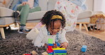 Girl, building blocks and toys for learning in home, education and playing on floor for development. Female person, creative activity and puzzle for geometric shape, happy and skills for kindergarten