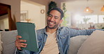 Tablet, laughing and man reading meme, comedy or watch funny video on social media in home. Technology, joke and happy person relax on sofa online for movie, film and streaming service app for show