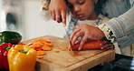 Hands, kid and mother cutting vegetables for food, learning or cooking healthy lunch in home kitchen. Child, parent and chopping board with knife closeup for carrots, organic meal or girl help family