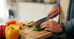 Cutting board, vegetables and hands with knife, kitchen and cooking for lunch, wood and meal prep in home. Wellness, recipe and person with ingredients, organic and chopping of food, hungry and house