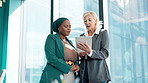 Tablet, meeting and business women in office consulting for online project, research and feedback. Corporate, professional and people on digital tech for website, internet and planning by window