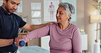 Physio, dumbbells and senior care in clinic, consultation exam and medical support for rehabilitation. Man, recovery and specialist for healing treatment, assessment and weights for helping woman