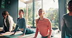 Yoga, exercise and class with stretching in studio for flexibility, holistic wellness and body balance on floor. Group, people and pilates with cobra pose for posture, mindfulness and spiritual zen