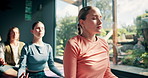 Yoga, class and meditation with lotus in studio for holistic wellness, mindfulness and spiritual healing on floor. People, woman and breathing on mat for mental health balance, peaceful and fitness