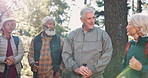 Talking, senior or friends hiking in forest for outdoor adventure or journey for travel in nature or woods. Group, trip or old people on outdoor holiday for retirement, walking or trekking to explore